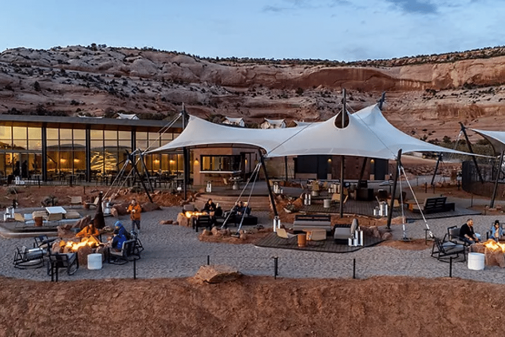 Canopy tents and fire pits at a desert canyon resort