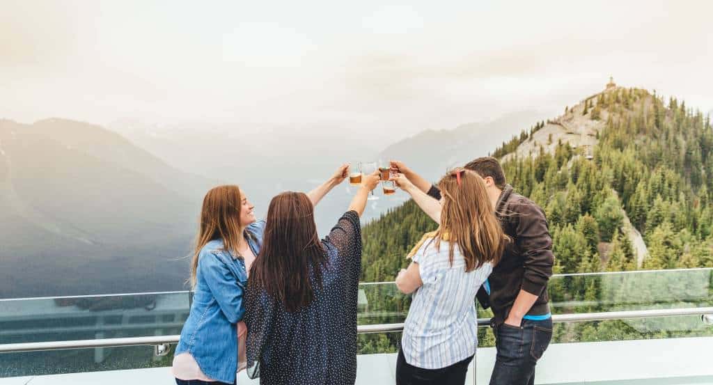 Friends raising a toast on a mountaintop deck