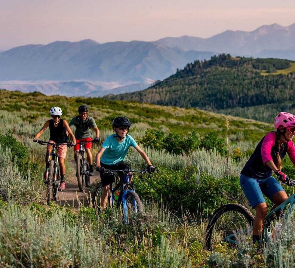 Group mountain biking on a trail near Deer Valley