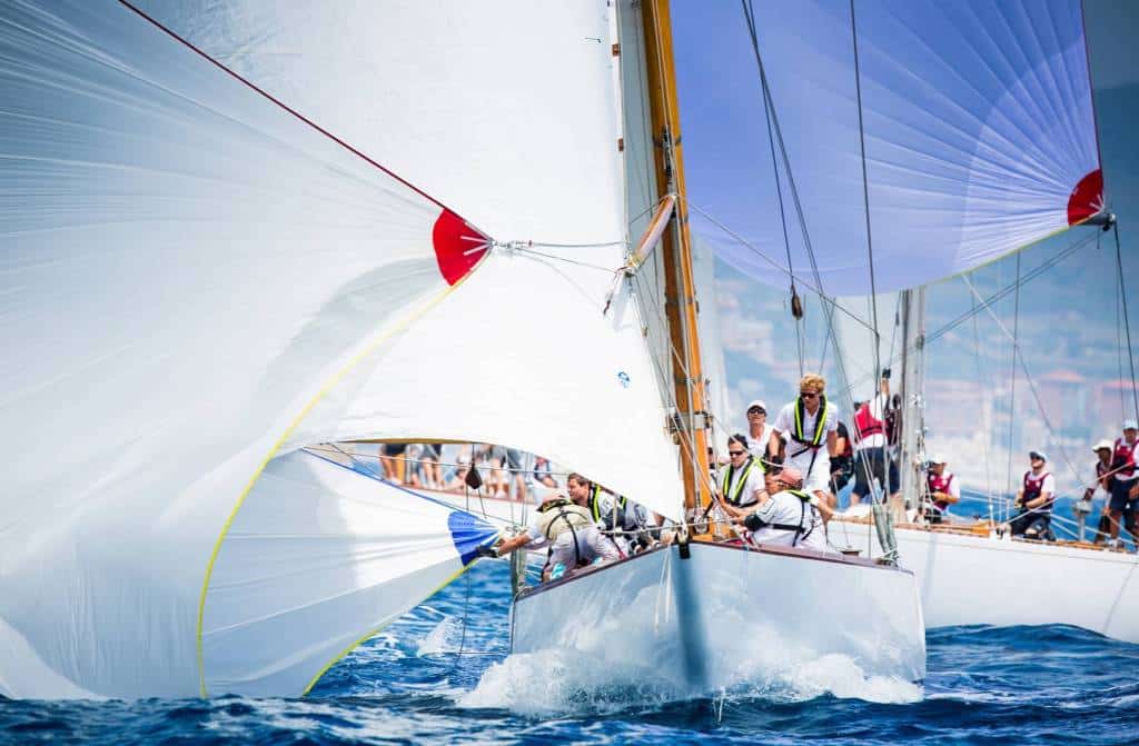 Sailing crews racing under full spinnakers on the Mediterranean