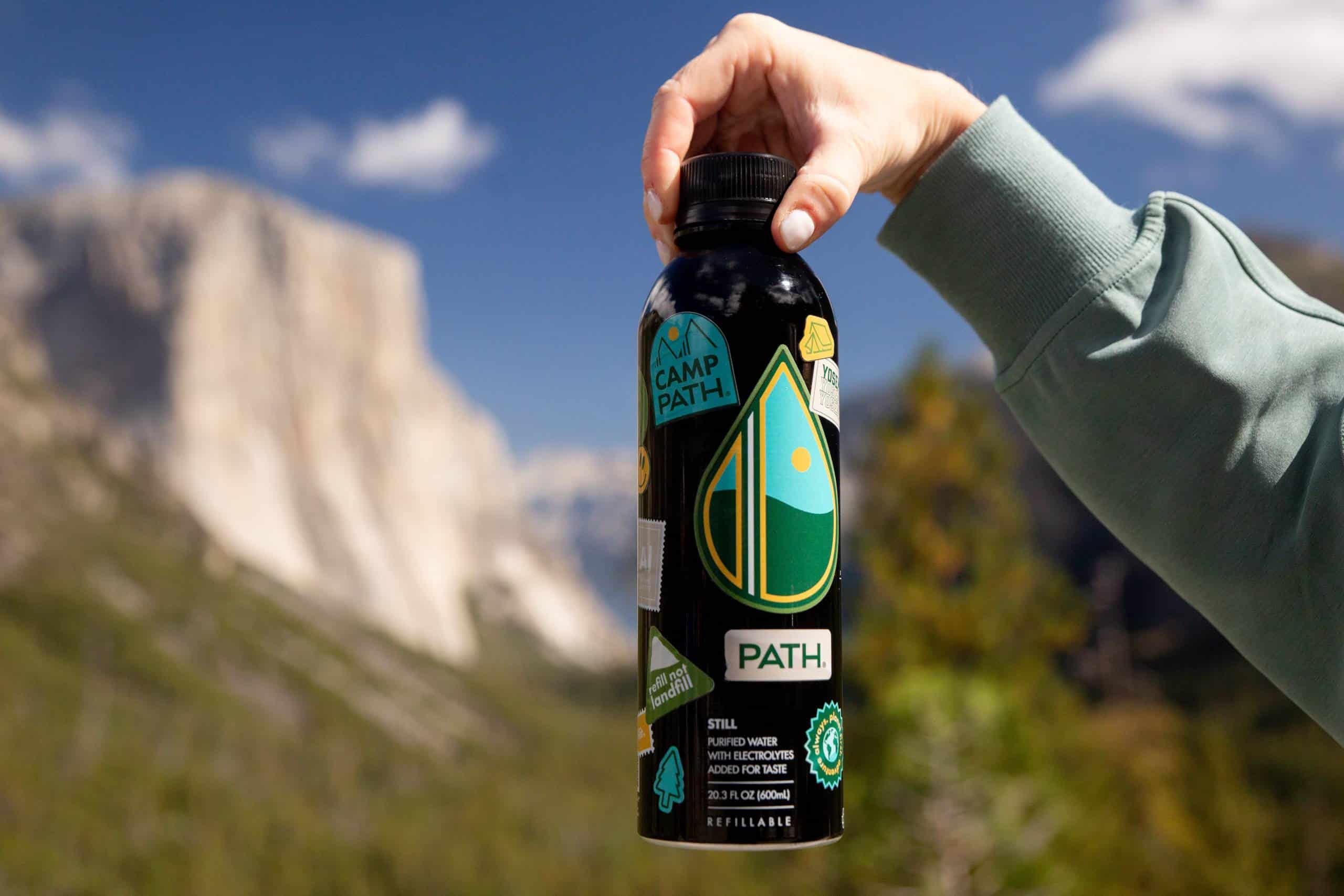Path water bottle held up in front of El Capitan in Yosemite