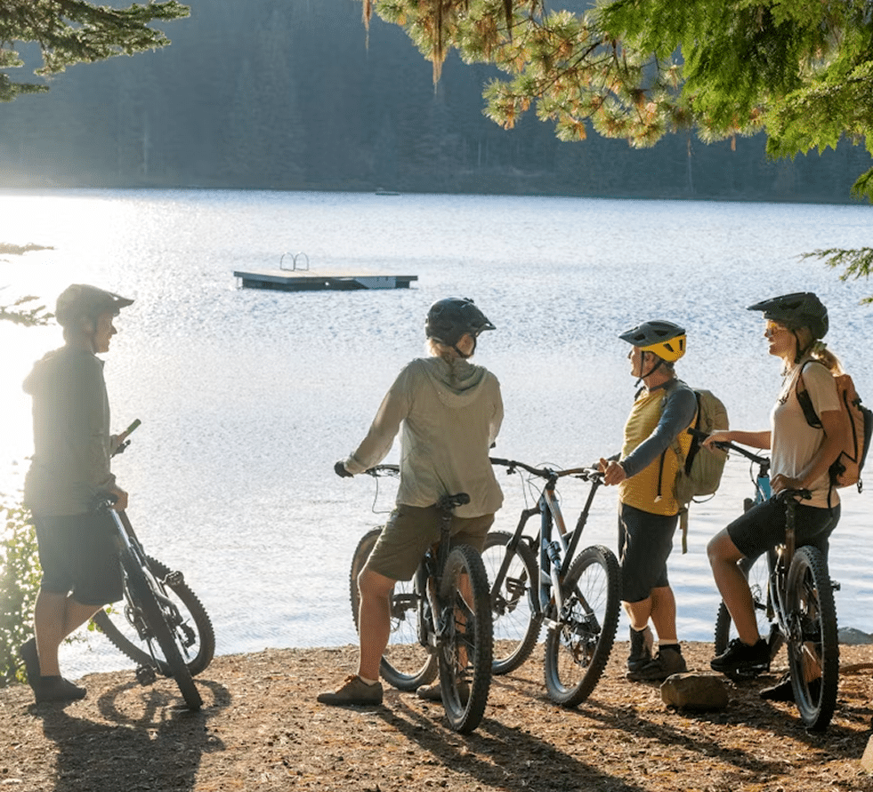 Mountain bikers beside an alpine lake