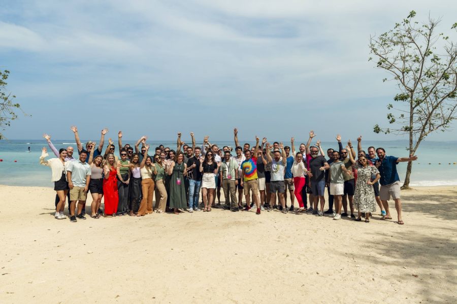 Large group celebrating on a beach retreat