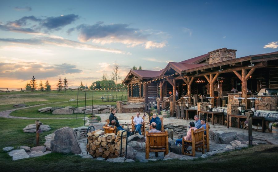 Leaders gathered around a lodge firepit