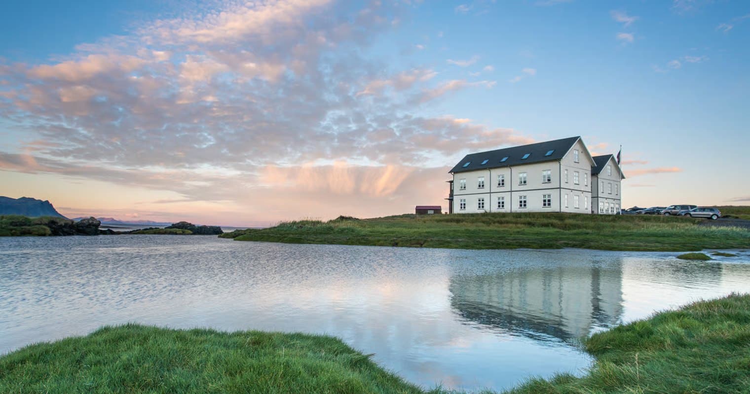Hótel Búðir reflected in a tidal pool at sunset on the Snæfellsnes Peninsula