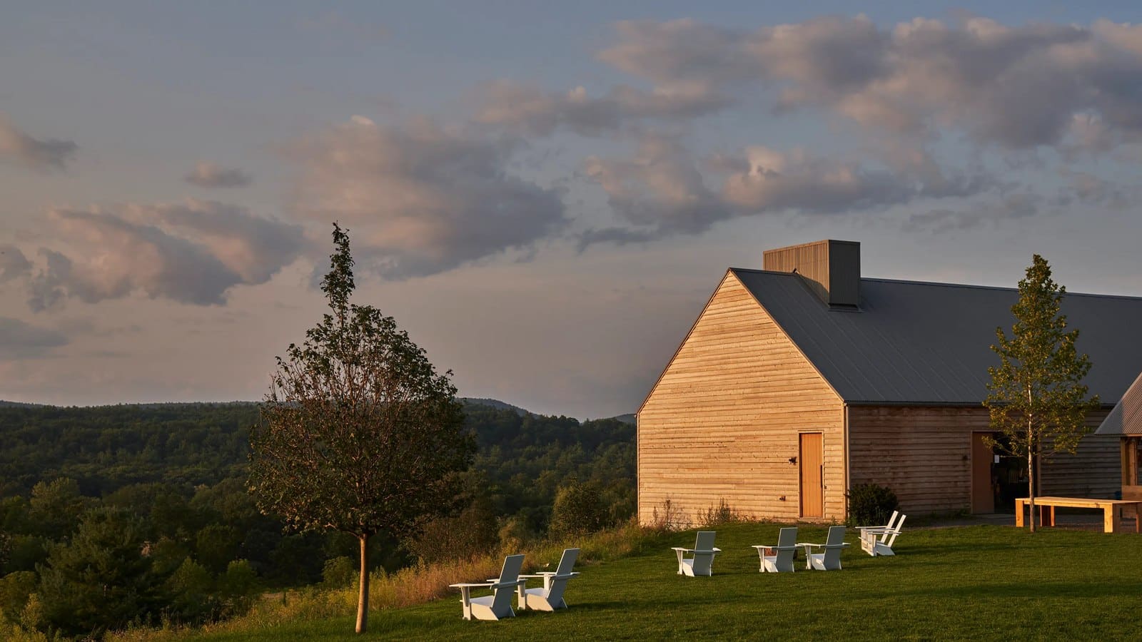 Barn and Adirondack chairs at Inness at sunset