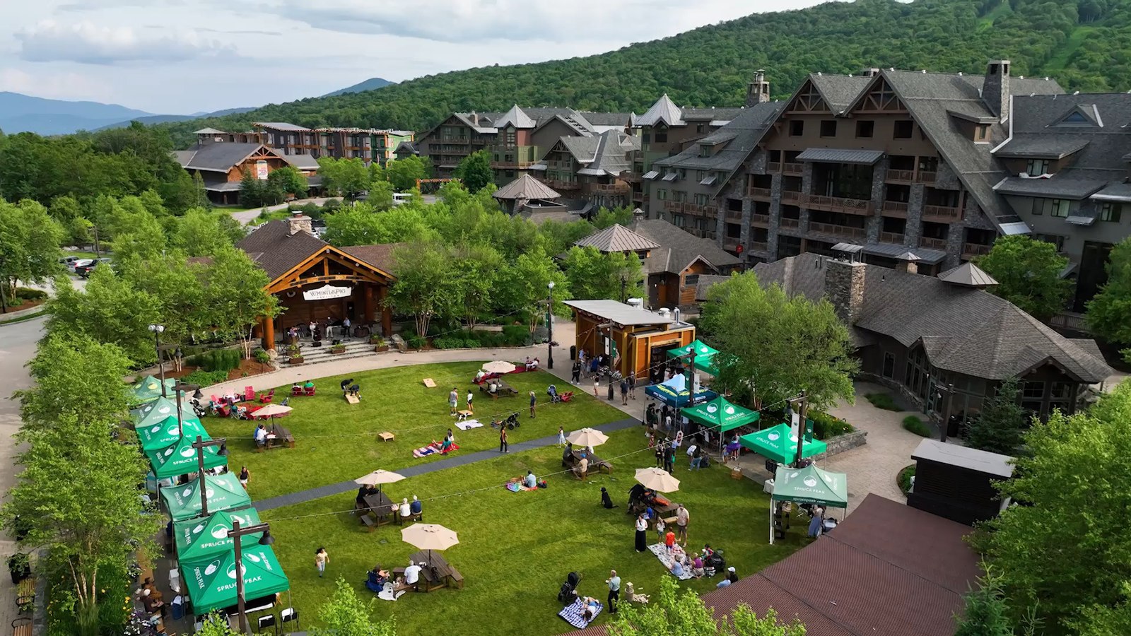 The Lodge at Spruce Peak and village green in summer, Stowe