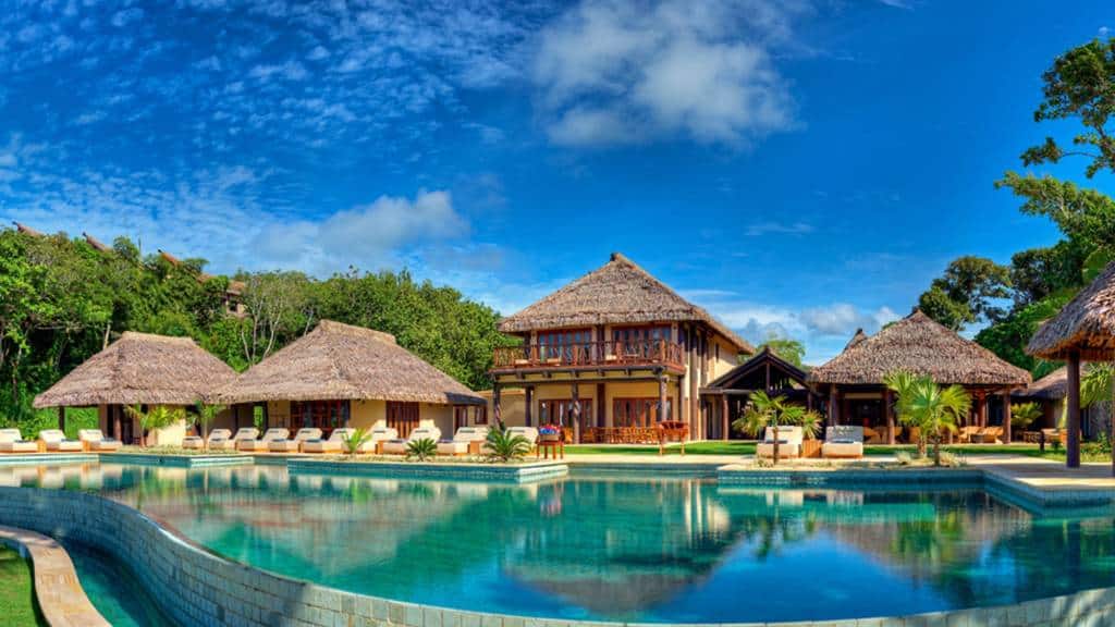 Thatched villas and pool at Nanuku Resort in Pacific Harbour, Fiji