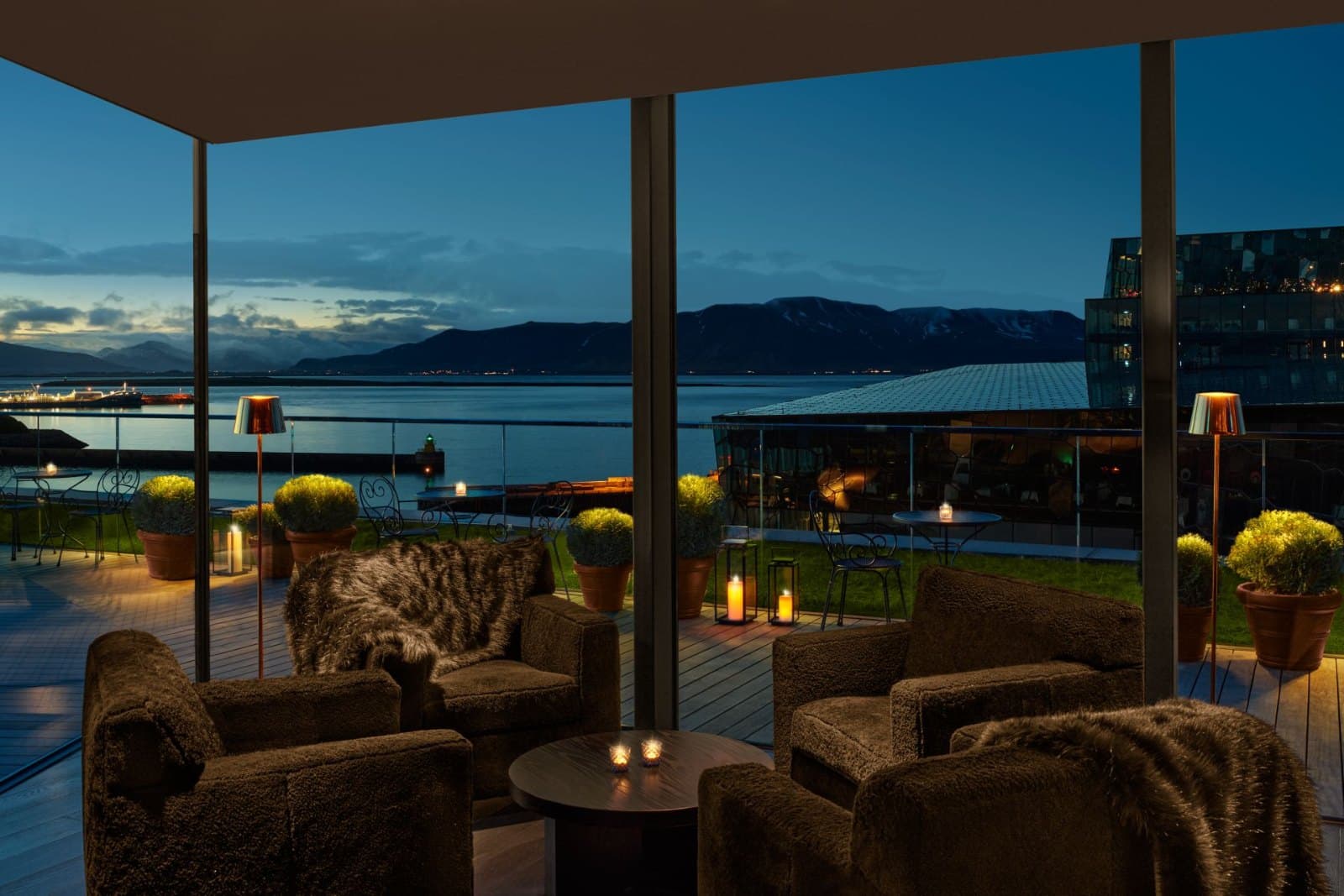 Rooftop terrace at The Reykjavik EDITION overlooking the Old Harbour at dusk