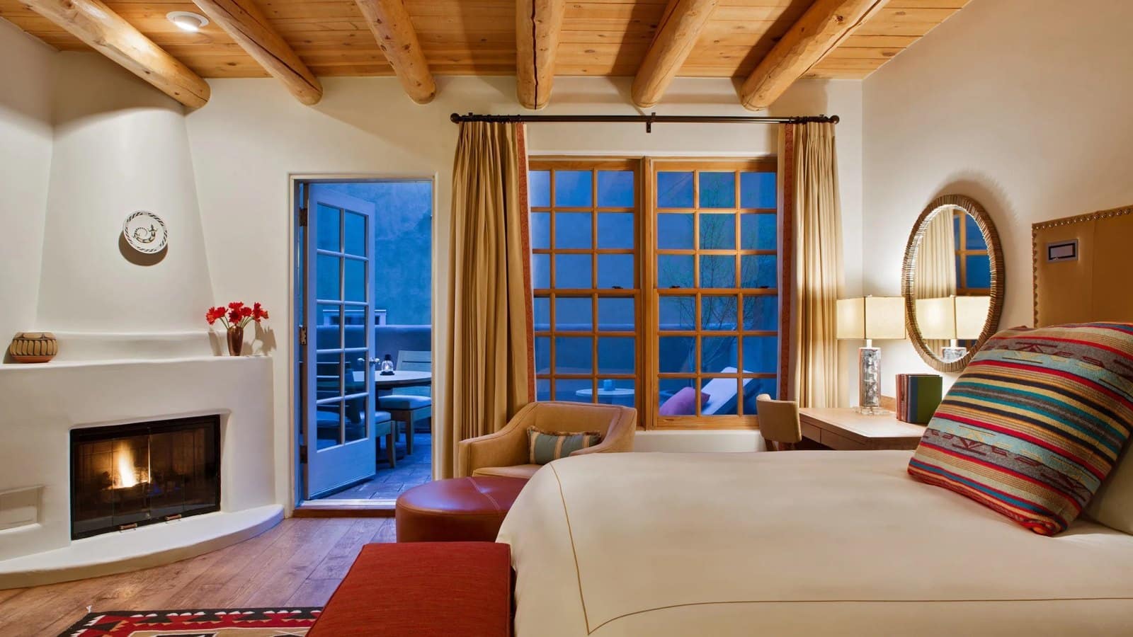 Guest room with a kiva fireplace at Rosewood Inn of the Anasazi in Santa Fe