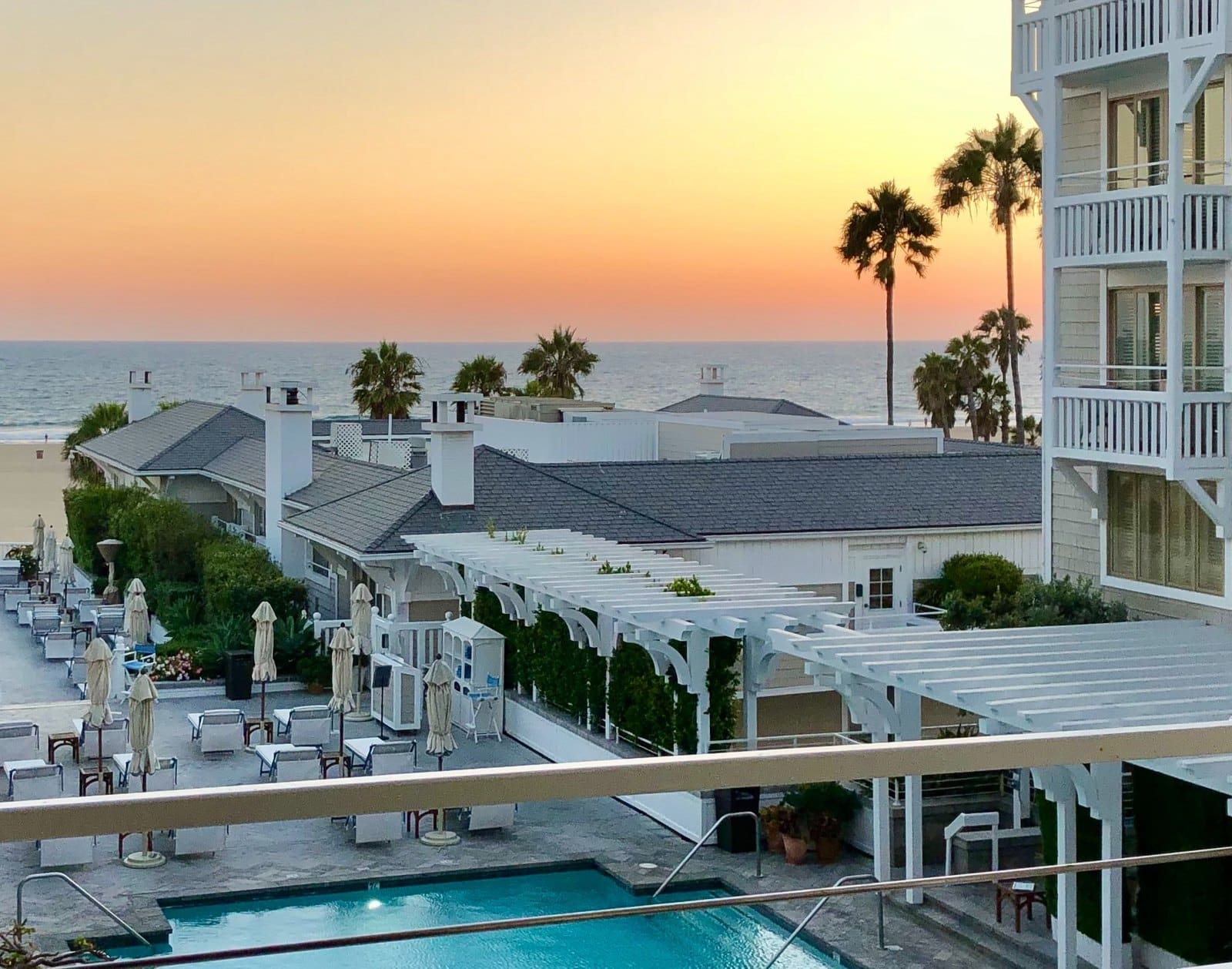 Pool deck and ocean at sunset at Shutters on the Beach in Santa Monica