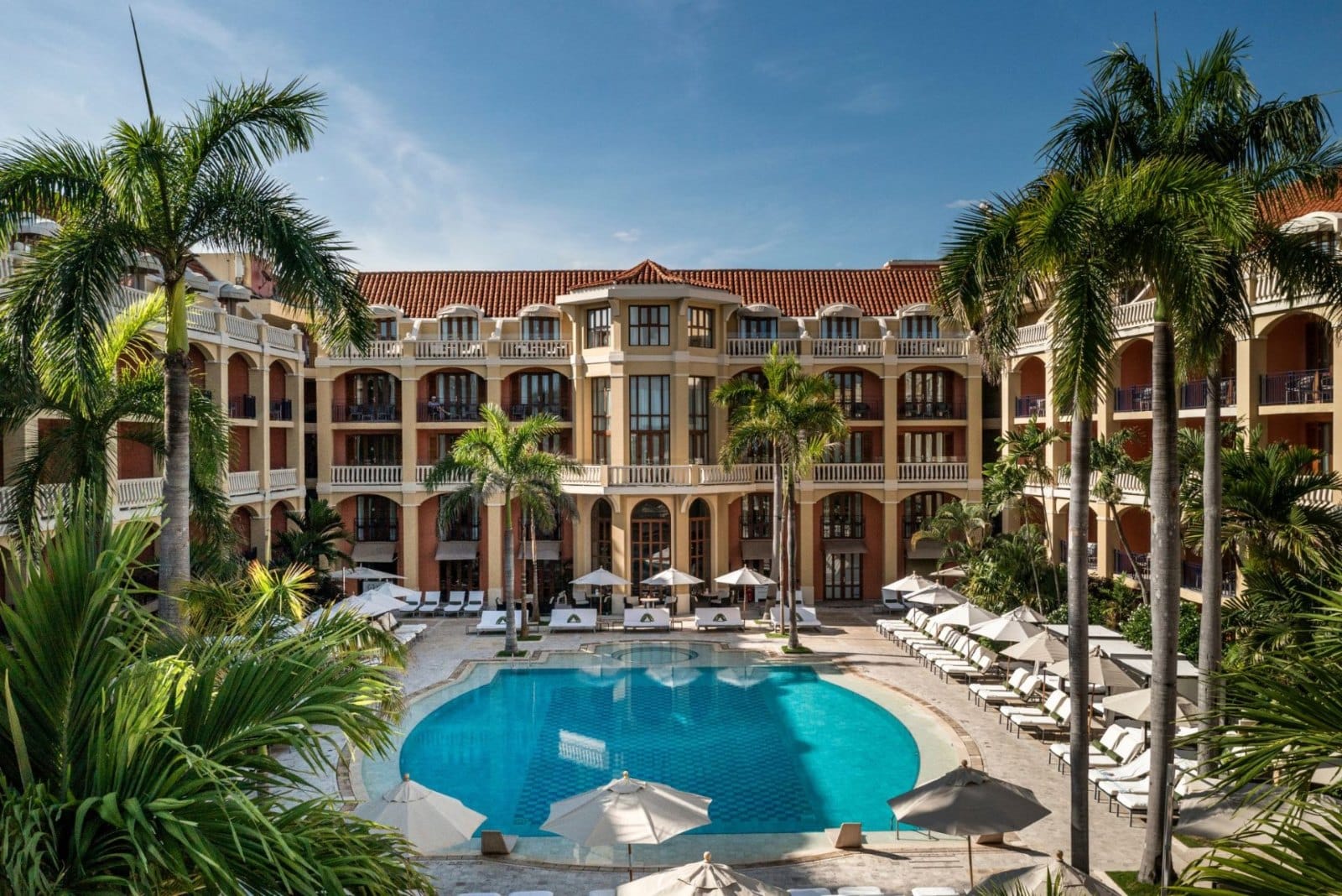 Palm-lined pool courtyard at Sofitel Legend Santa Clara in Cartagena