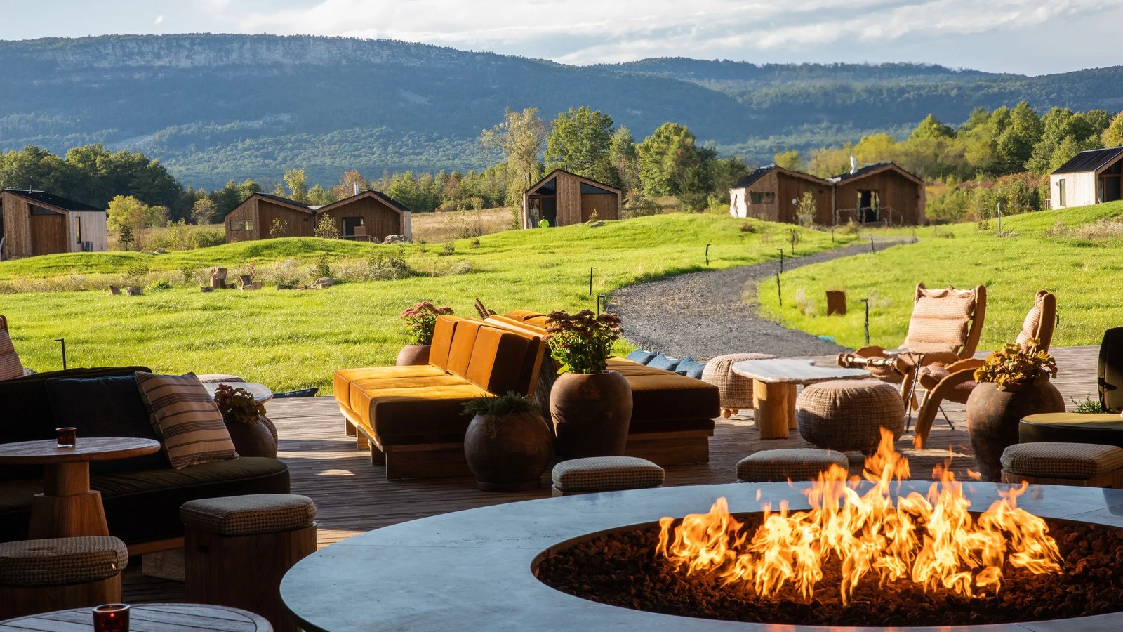 Cabins and fire pit at Wildflower Farms with the Shawangunk Ridge behind