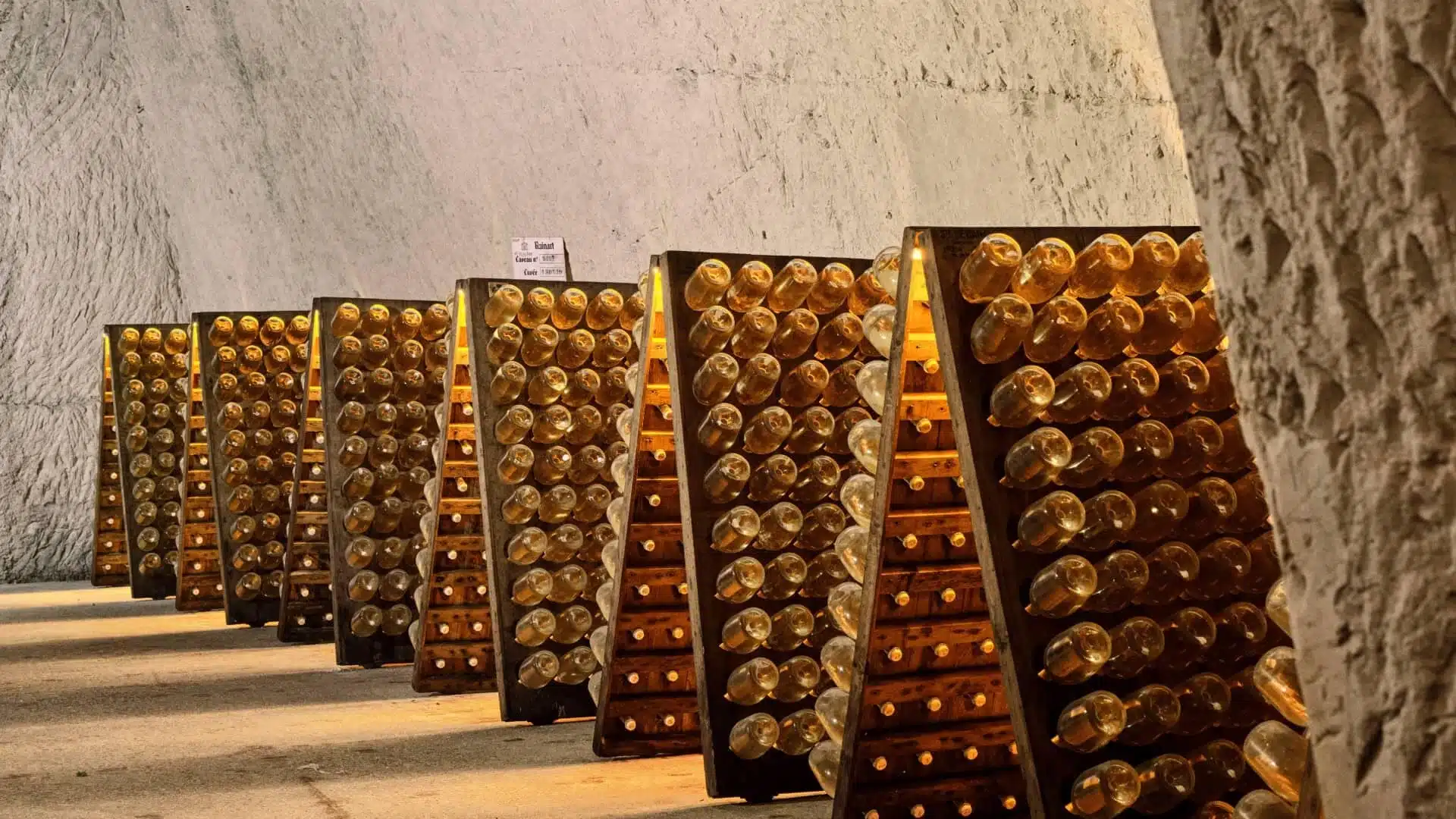 Riddling racks of champagne bottles in chalk cellars in Reims