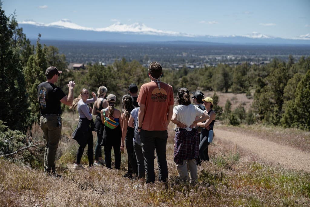 A retreat group on a guided hike above a valley