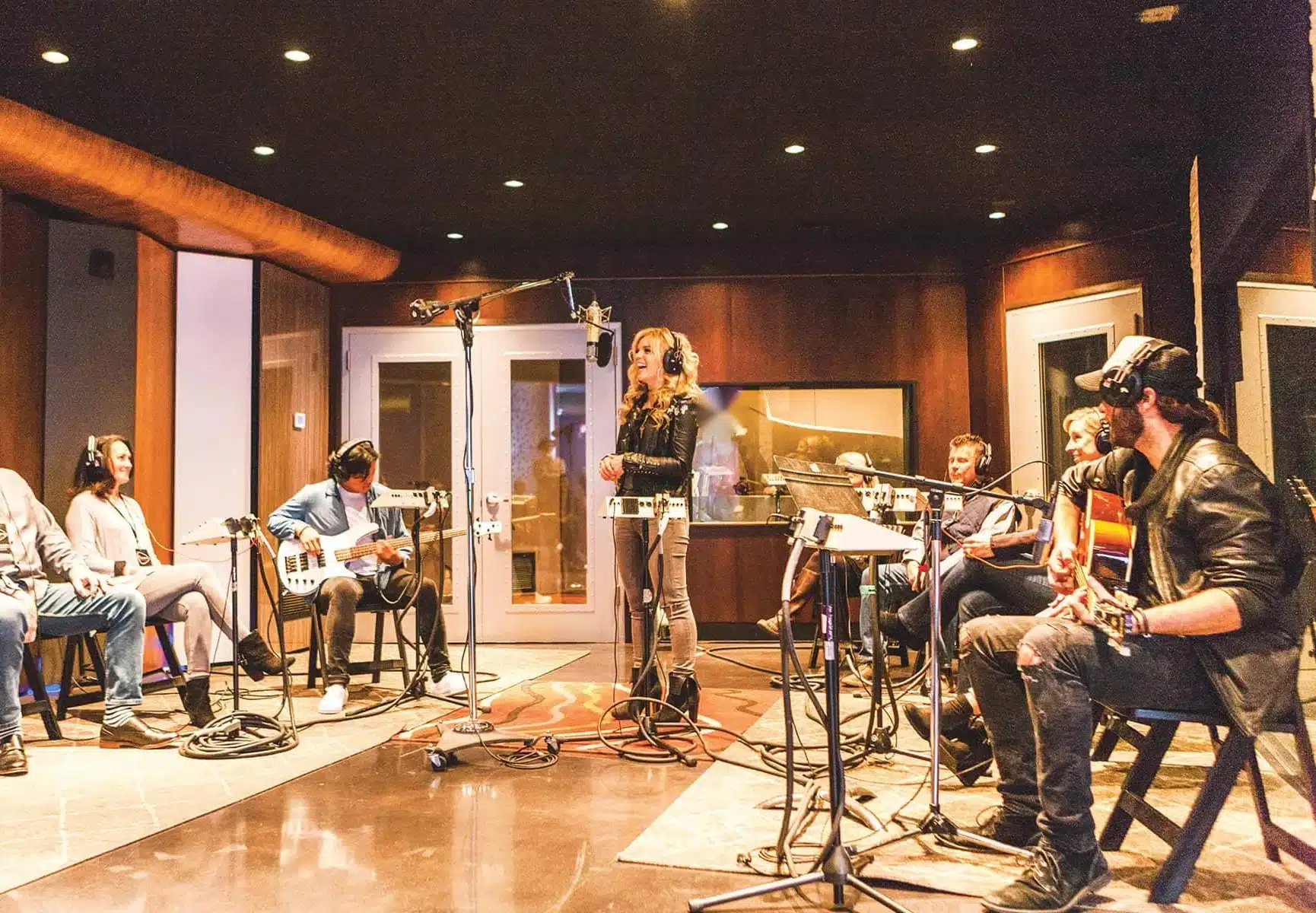 A team writing and recording a song with Nashville musicians in a studio